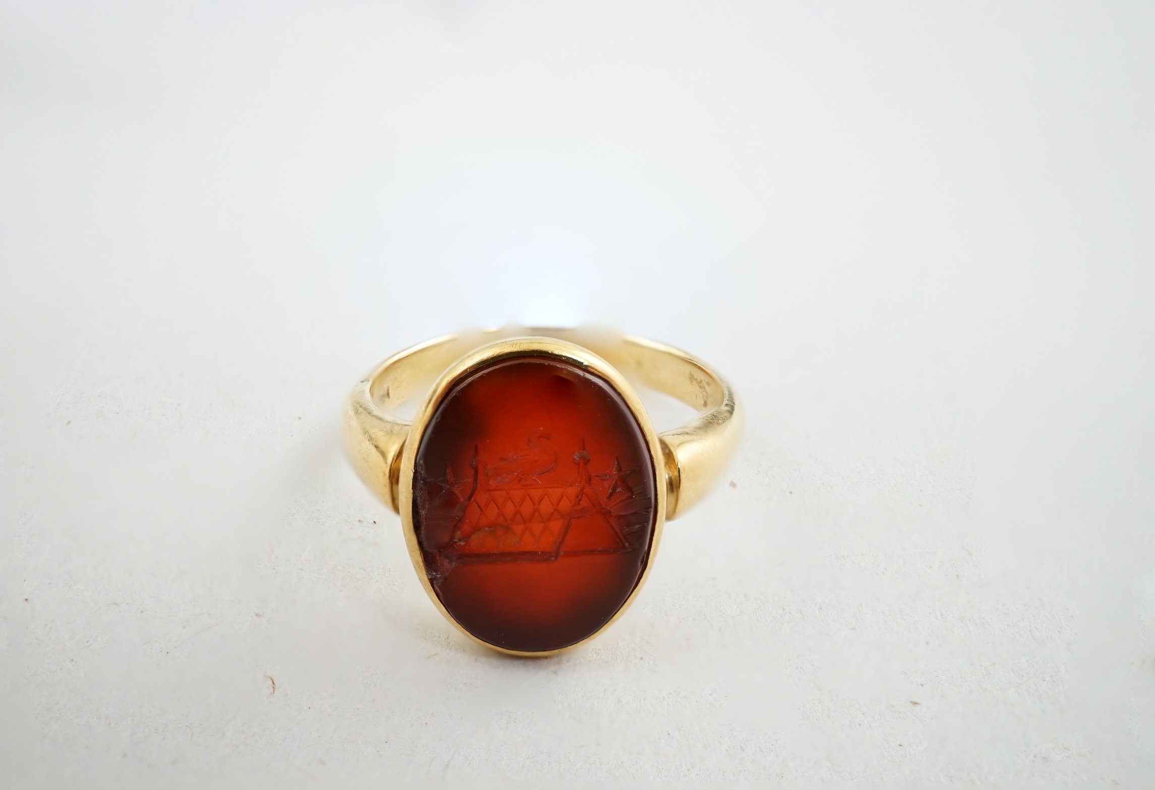 A Victorian 18ct gold and intaglio carnelian set child's signet ring